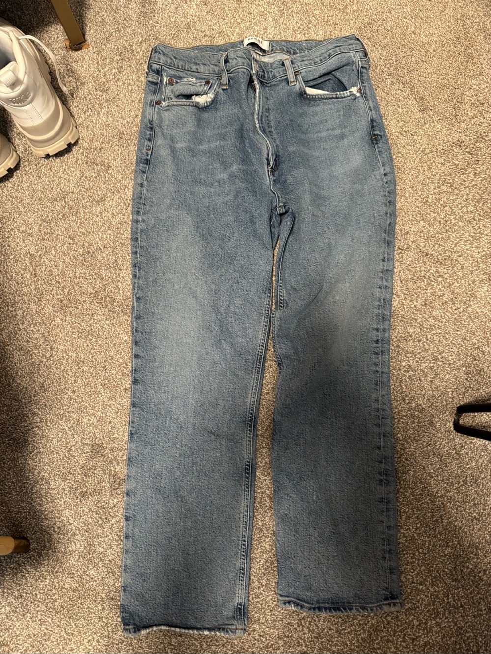 AGOLDE med/high rise straight jeans in a light to medium blue wash.